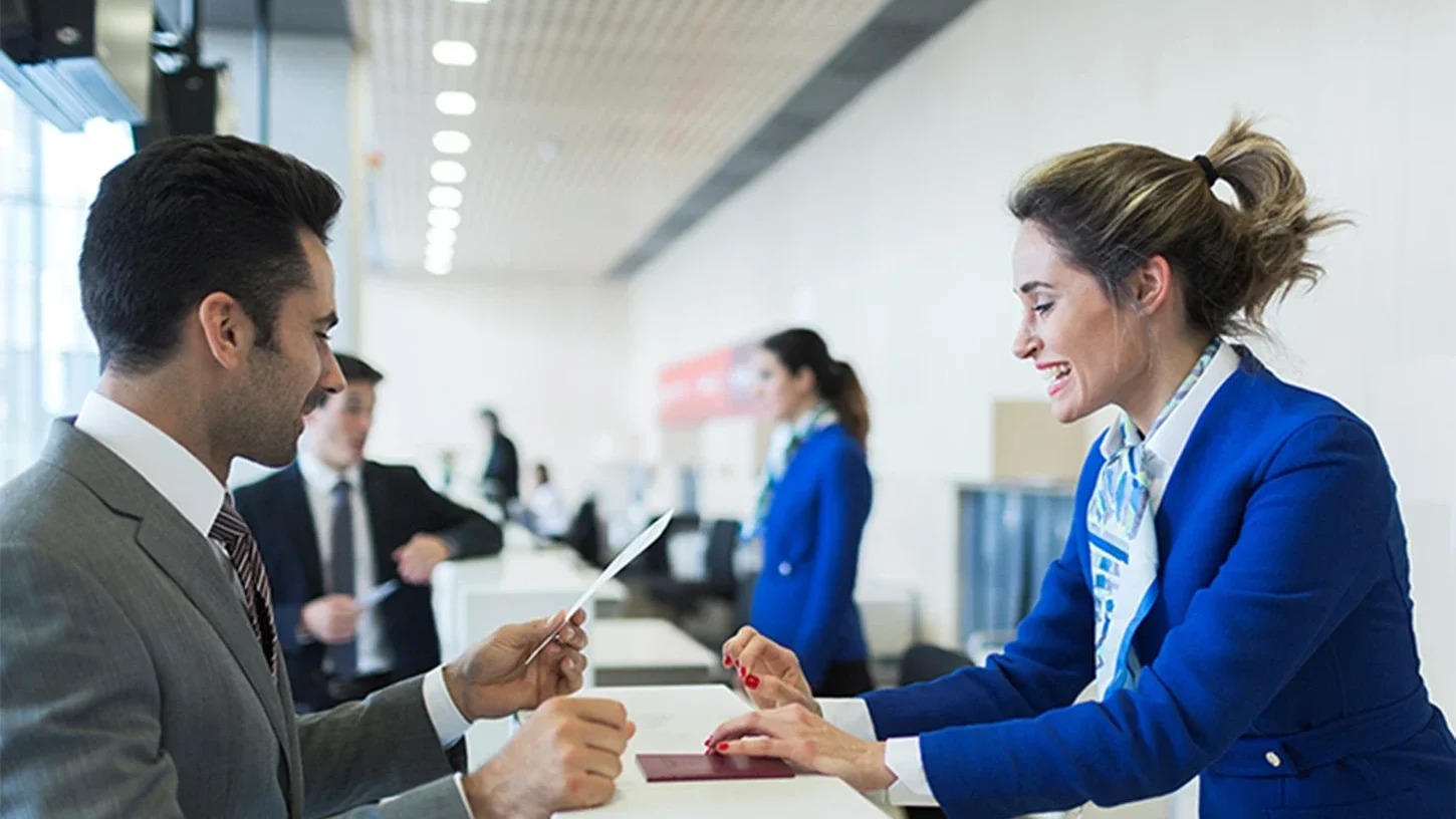 Airport Management staff helping a traveler with passports